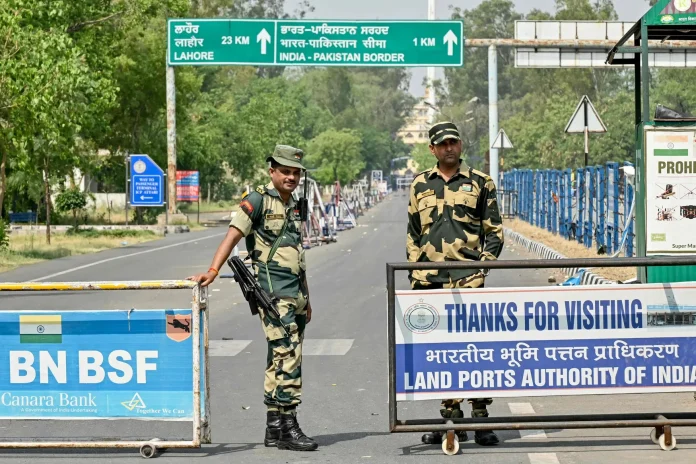 Indian Border Security Force (BSF) personnel stand guard near the India-Pakistan Wagah border post.